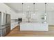 Spacious kitchen with white cabinets, stainless steel appliances, and an island with pendant lighting at 905 N Willow Ave, Tampa, FL 33606