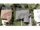 Aerial view of a house showing the roof, yard and screened in pool at 916 Bunker View Dr, Apollo Beach, FL 33572