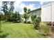 Beautiful backyard showcasing lush green grass, various plants and foliage, and a charming garden at 916 Bunker View Dr, Apollo Beach, FL 33572