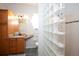 Stylish bathroom boasts a glass block walk-in shower, wood vanity with storage and tiled floors at 916 Bunker View Dr, Apollo Beach, FL 33572