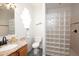 Well-lit bathroom featuring a glass block walk-in shower, granite countertop vanity and tiled floor at 916 Bunker View Dr, Apollo Beach, FL 33572