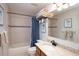 Cozy bathroom featuring tiled tub, granite countertop and mirror offering a relaxing and inviting space at 916 Bunker View Dr, Apollo Beach, FL 33572