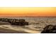 Scenic beach view with a rock barrier and city skyline in the distance at 916 Bunker View Dr, Apollo Beach, FL 33572