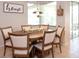 Cozy dining area with round table and six chairs with oak cabinets at 916 Bunker View Dr, Apollo Beach, FL 33572