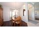 Elegant dining room featuring a chandelier, wood floors, and a view of the front entrance at 916 Bunker View Dr, Apollo Beach, FL 33572