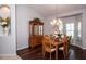 Well-lit dining room featuring a wooden table, chairs, chandelier, and lovely wooden china cabinet at 916 Bunker View Dr, Apollo Beach, FL 33572