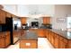 Bright kitchen with stainless steel appliances, dark countertops, and oak cabinets at 916 Bunker View Dr, Apollo Beach, FL 33572
