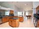 Open floor plan with oak kitchen featuring a large island and stainless steel appliances at 916 Bunker View Dr, Apollo Beach, FL 33572