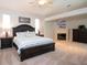 Relaxing main bedroom with fireplace, carpet floors, and natural light at 916 Bunker View Dr, Apollo Beach, FL 33572