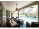 Inviting outdoor patio with comfortable seating, a ceiling fan, and a screened-in pool at 916 Bunker View Dr, Apollo Beach, FL 33572