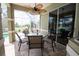 Outdoor patio featuring screened-in pool views, comfortable seating, and a ceiling fan at 916 Bunker View Dr, Apollo Beach, FL 33572