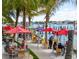 Outdoor dining area with tables and umbrellas overlooking the waterfront at 916 Bunker View Dr, Apollo Beach, FL 33572