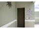 Outdoor shower area featuring tile details and a door leading to the backyard at 916 Bunker View Dr, Apollo Beach, FL 33572