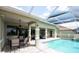 Outdoor screened in pool with outdoor dining and lounge area at 916 Bunker View Dr, Apollo Beach, FL 33572