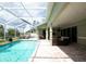 Enclosed screened-in pool with lounge chairs and patio furniture, perfect for relaxation at 916 Bunker View Dr, Apollo Beach, FL 33572
