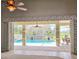 View of the sparkling pool and screened-in lanai from the home's interior, showcasing indoor-outdoor living at 916 Bunker View Dr, Apollo Beach, FL 33572