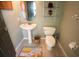 Charming powder room with a pedestal sink and toilet at 916 Bunker View Dr, Apollo Beach, FL 33572