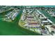 Aerial view showcasing waterfront condominiums with docks and lush landscaping at 1 Windrush Blvd # 84, Indian Rocks Beach, FL 33785