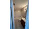 Bathroom with white tiled shower-tub combination, a white toilet, and a sink with wooden cabinets at 1 Windrush Blvd # 84, Indian Rocks Beach, FL 33785