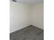 This bedroom features sleek white walls, modern gray flooring, and electrical outlets at 1 Windrush Blvd # 84, Indian Rocks Beach, FL 33785