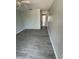 Bedroom with gray flooring leads to the hallway with a white closet and light coming through a window at 1 Windrush Blvd # 84, Indian Rocks Beach, FL 33785