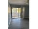 Bedroom with gray flooring and glass sliding doors that lead to a balcony, with a ceiling fan included at 1 Windrush Blvd # 84, Indian Rocks Beach, FL 33785