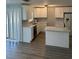 Bright kitchen features white cabinets, stainless appliances, and granite countertops at 1 Windrush Blvd # 84, Indian Rocks Beach, FL 33785