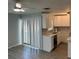 Efficient kitchen features white cabinets and stainless sink with natural light from windows at 1 Windrush Blvd # 84, Indian Rocks Beach, FL 33785