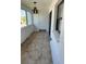 Enclosed porch with decorative tile flooring, white walls, and view of the outside at 1 Windrush Blvd # 84, Indian Rocks Beach, FL 33785