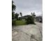Spacious backyard featuring a versatile garage, mature trees, and a well-manicured lawn at 114 N Arcturas Ave, Clearwater, FL 33765