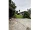 Expansive backyard with lush greenery, patio, storage shed, offering a private outdoor space at 114 N Arcturas Ave, Clearwater, FL 33765