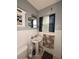 This bathroom features a pedestal sink, a window, and a tiled wall at 114 N Arcturas Ave, Clearwater, FL 33765