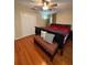 Bedroom with beautiful wood flooring, a ceiling fan, and a closet for storage at 114 N Arcturas Ave, Clearwater, FL 33765