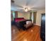 Spacious bedroom with hardwood floors, ceiling fan, and natural light from two windows at 114 N Arcturas Ave, Clearwater, FL 33765