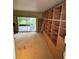 Bright bedroom with a custom bookcase, and access to the porch through a glass door at 114 N Arcturas Ave, Clearwater, FL 33765