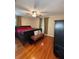 Bedroom with wood floors and dark furniture at 114 N Arcturas Ave, Clearwater, FL 33765