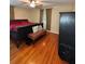 Bedroom featuring hardwood floors, a ceiling fan, and natural light streaming through the windows at 114 N Arcturas Ave, Clearwater, FL 33765