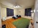 Comfortable bedroom includes hardwood floors, ceiling fan, window, and playful decor at 114 N Arcturas Ave, Clearwater, FL 33765