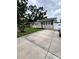 Charming single-story home featuring a well-maintained lawn, a cozy porch, and a concrete driveway at 114 N Arcturas Ave, Clearwater, FL 33765