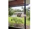 Backyard featuring a garage with lush greenery, offering a private and serene setting at 114 N Arcturas Ave, Clearwater, FL 33765
