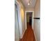 The hallway has hardwood floors and a view into another room at 114 N Arcturas Ave, Clearwater, FL 33765
