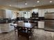 Bright and spacious kitchen featuring white cabinets, stainless appliances, and a center island with seating at 114 N Arcturas Ave, Clearwater, FL 33765