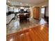 Bright kitchen with white cabinets, stainless steel appliances, brown countertops, and view of the dining room at 114 N Arcturas Ave, Clearwater, FL 33765