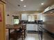 Bright, spacious kitchen with white cabinetry, stainless steel appliances, and a center island with seating at 114 N Arcturas Ave, Clearwater, FL 33765