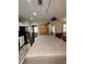 The kitchen has a large table with an overhead track light and an archway leading to other rooms at 114 N Arcturas Ave, Clearwater, FL 33765
