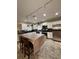 Bright kitchen featuring white cabinets, stainless steel appliances, brown countertops and unique hanging lights at 114 N Arcturas Ave, Clearwater, FL 33765