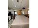 The kitchen has a large table with an overhead track light and an archway leading to other rooms at 114 N Arcturas Ave, Clearwater, FL 33765
