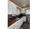 Close up of the kitchen featuring a dark countertop and mosaic backsplash at 114 N Arcturas Ave, Clearwater, FL 33765