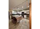Bright kitchen with white cabinets, stainless steel appliances, brown countertops, and wood armoire at 114 N Arcturas Ave, Clearwater, FL 33765