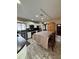 Bright kitchen with white cabinets, stainless steel appliances, brown countertops, and doorway to the front of the house at 114 N Arcturas Ave, Clearwater, FL 33765
